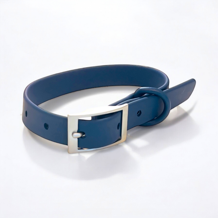 Navy blue waterproof dog collar on a white surface